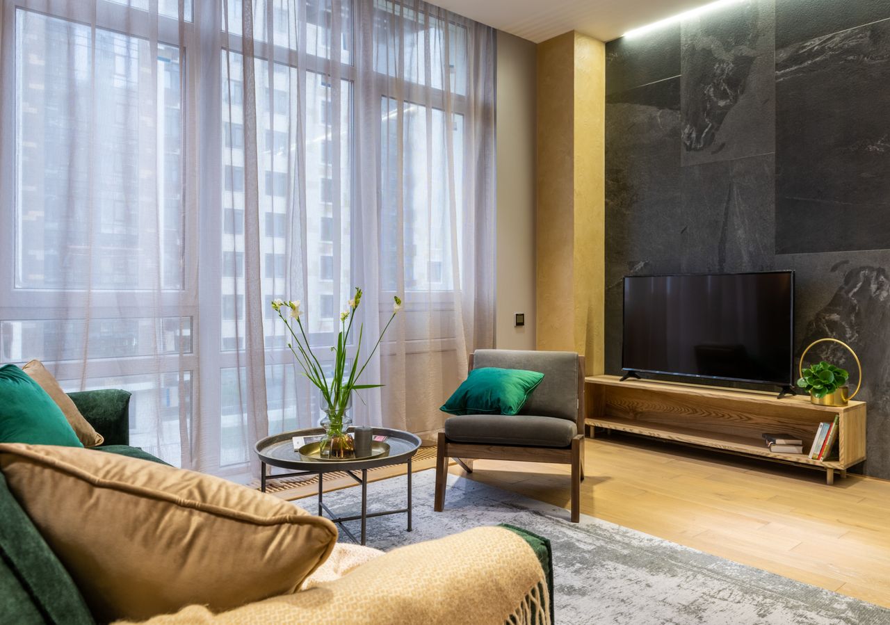 services-04 A luxurious living room featuring modern interior design with stylish furniture and decor.